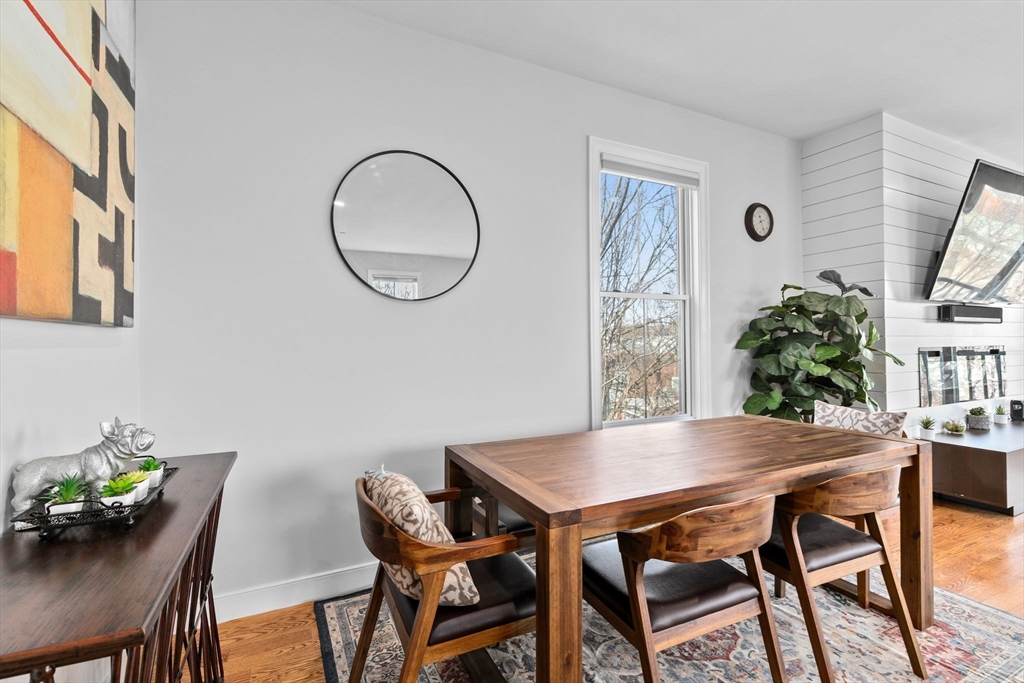 17 Centre Street, Unit 2 Boston, MA 02119 - Photo 8 of 34 a view of a dining room with furniture and a potted plant