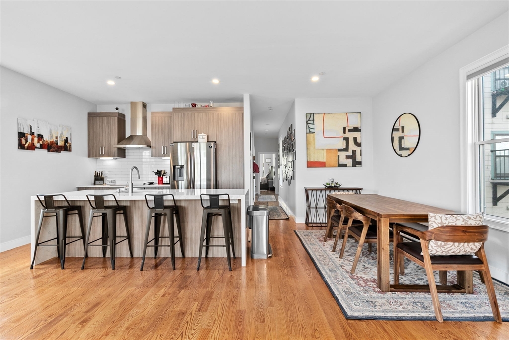 17 Centre Street, Unit 2 Boston, MA 02119 - Photo 10 of 34 a living room with stainless steel appliances furniture a rug and a kitchen view