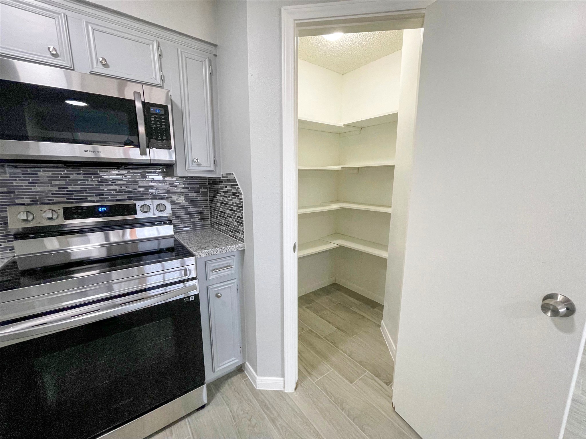 23460 Smith Road Porter, TX 77365 - Photo 20 of 46 a kitchen with a stove and a microwave