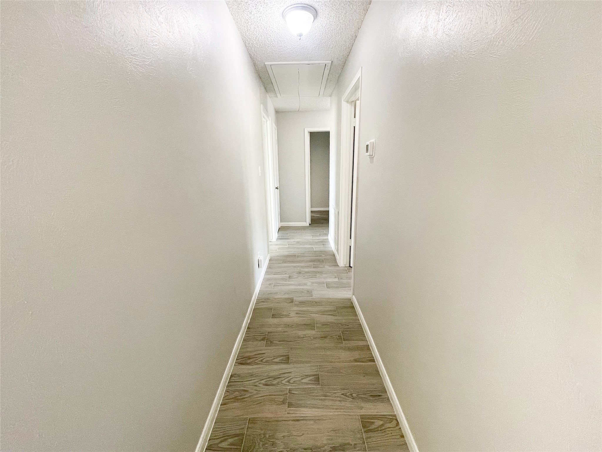 23460 Smith Road Porter, TX 77365 - Photo 23 of 46 a view of a hallway with wooden floor