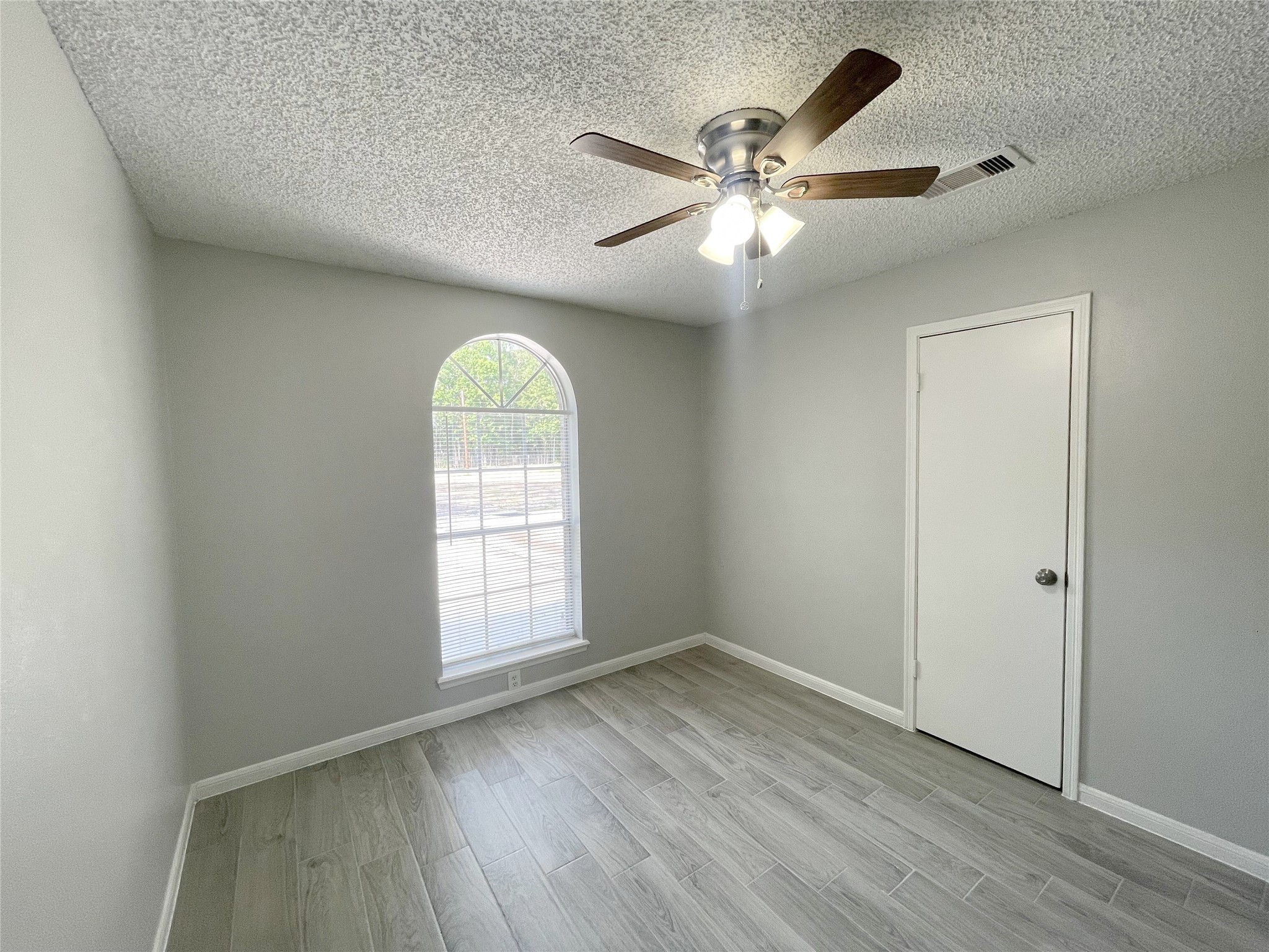 23460 Smith Road Porter, TX 77365 - Photo 24 of 46 an empty room with wooden floor fan and windows