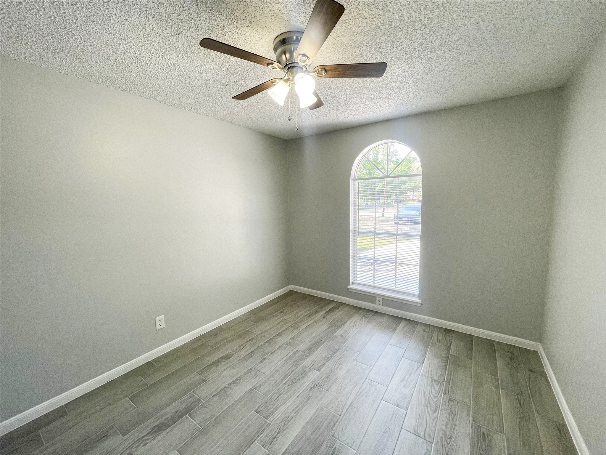 23460 Smith Road Porter, TX 77365 - Photo 26 of 46 an empty room with wooden floor chandelier fan and windows