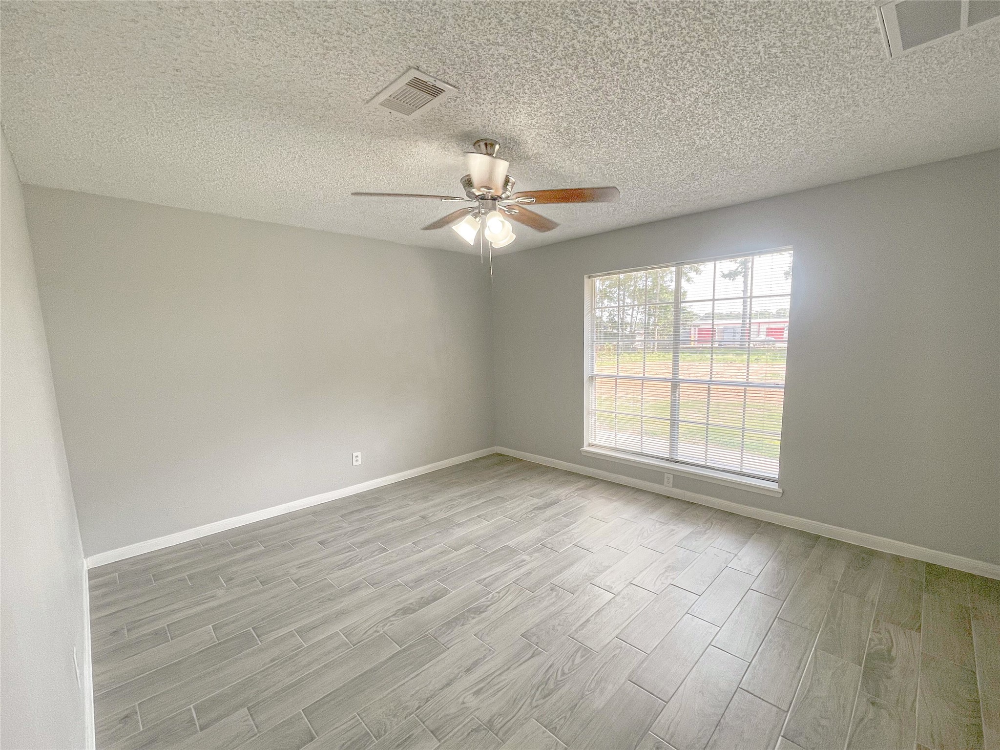 23460 Smith Road Porter, TX 77365 - Photo 28 of 46 an empty room with wooden floor and windows
