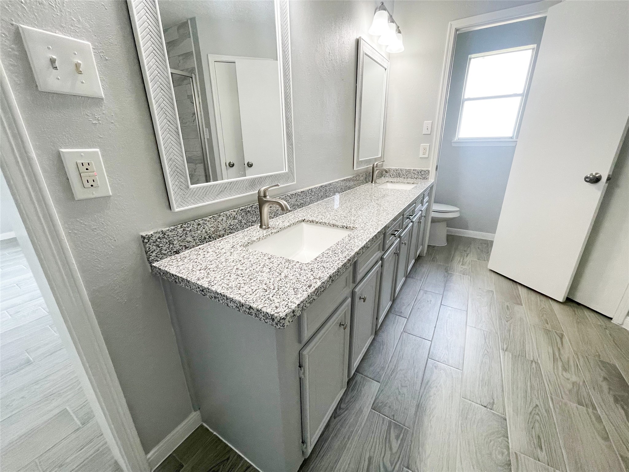 23460 Smith Road Porter, TX 77365 - Photo 31 of 46 a bathroom with a granite countertop sink and a mirror