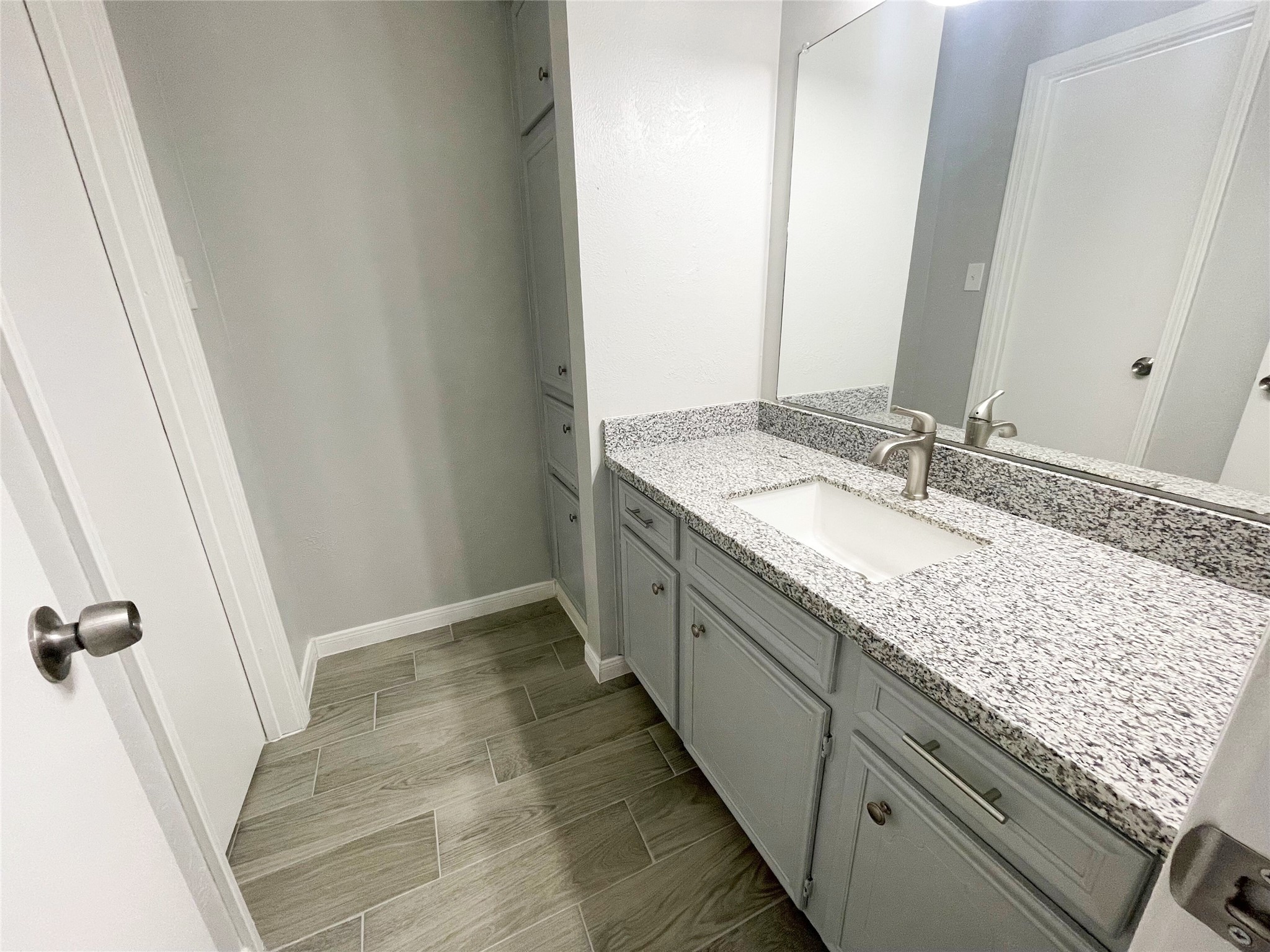 23460 Smith Road Porter, TX 77365 - Photo 33 of 46 a bathroom with a granite countertop sink and a mirror