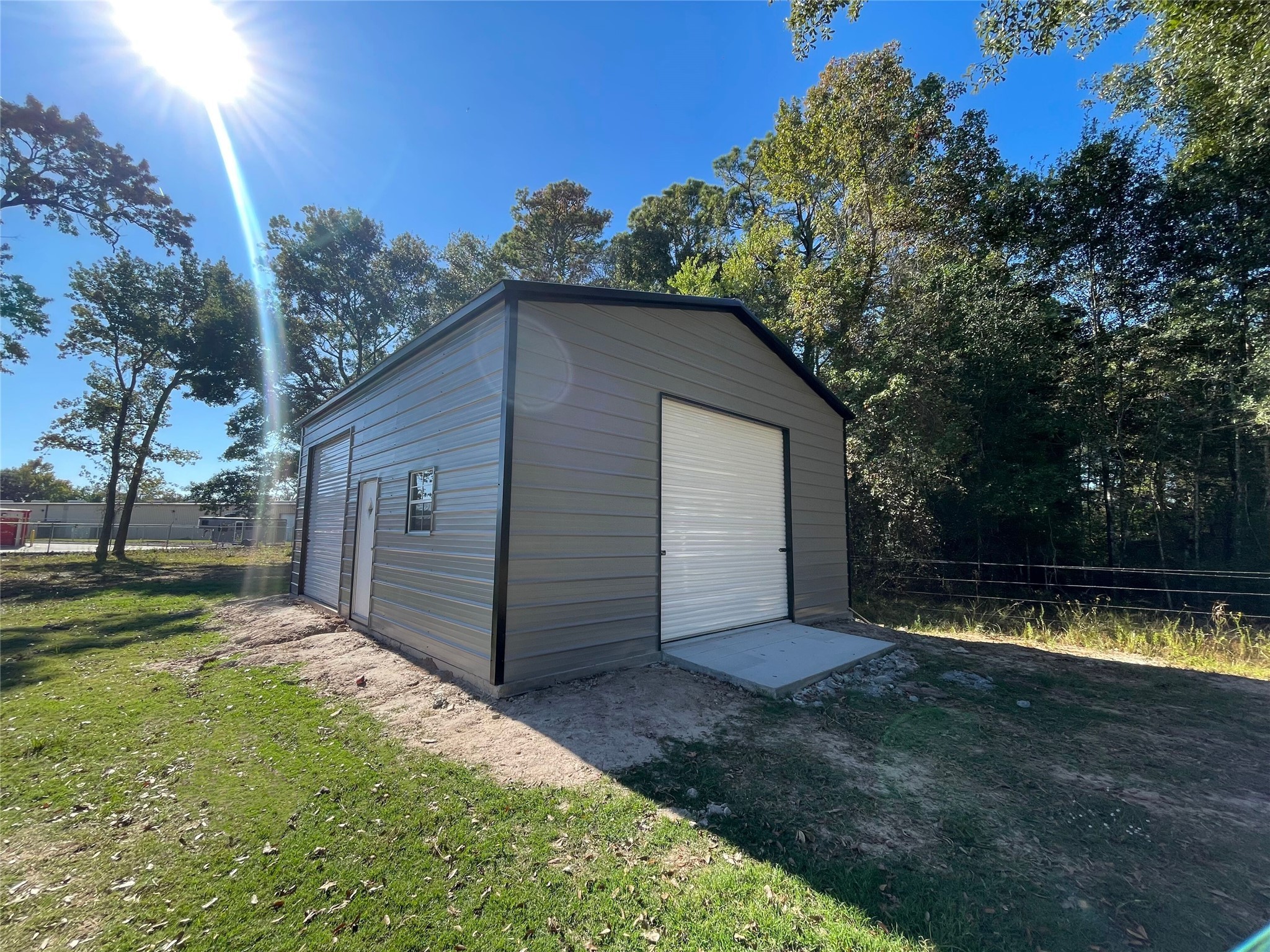 23460 Smith Road Porter, TX 77365 - Photo 5 of 46 a view of a backyard with a small cabin and a chair