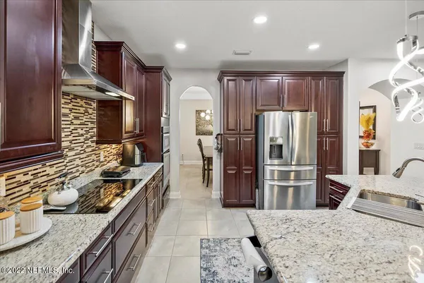 a kitchen with stainless steel appliances granite countertop a refrigerator stove and oven