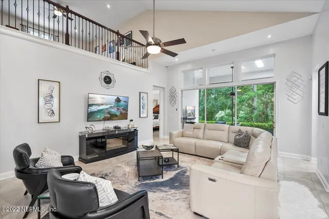 a living room with furniture fireplace and a large window