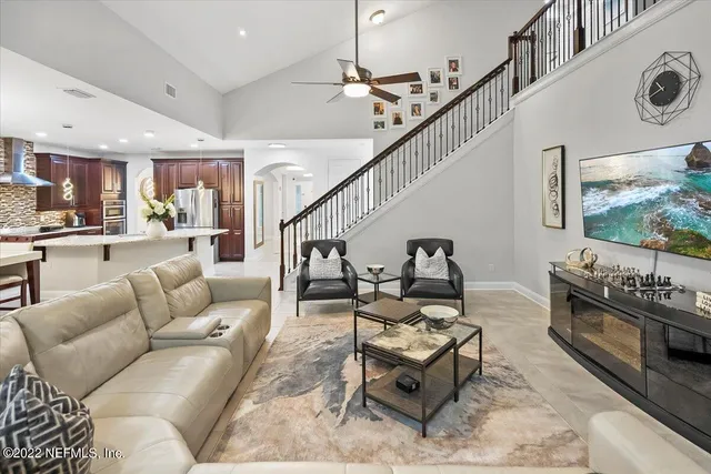 a living room with furniture and a floor to ceiling window