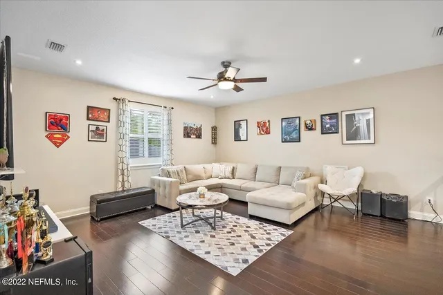 a living room with furniture a rug and a window