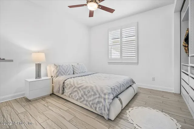 a spacious bedroom with a bed and a chandelier