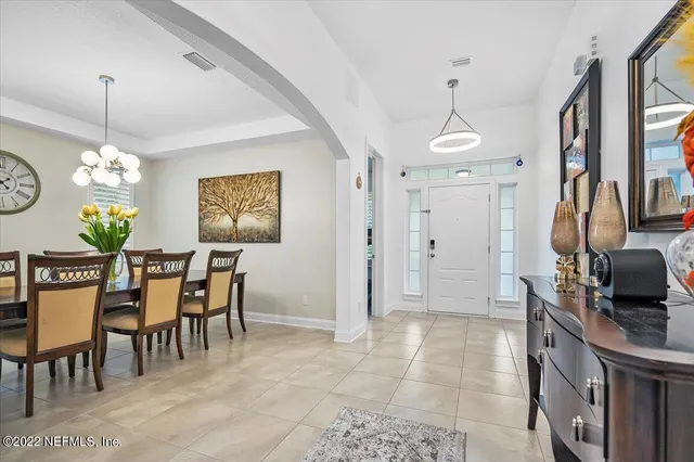 a view of a dining room with furniture and chandelier