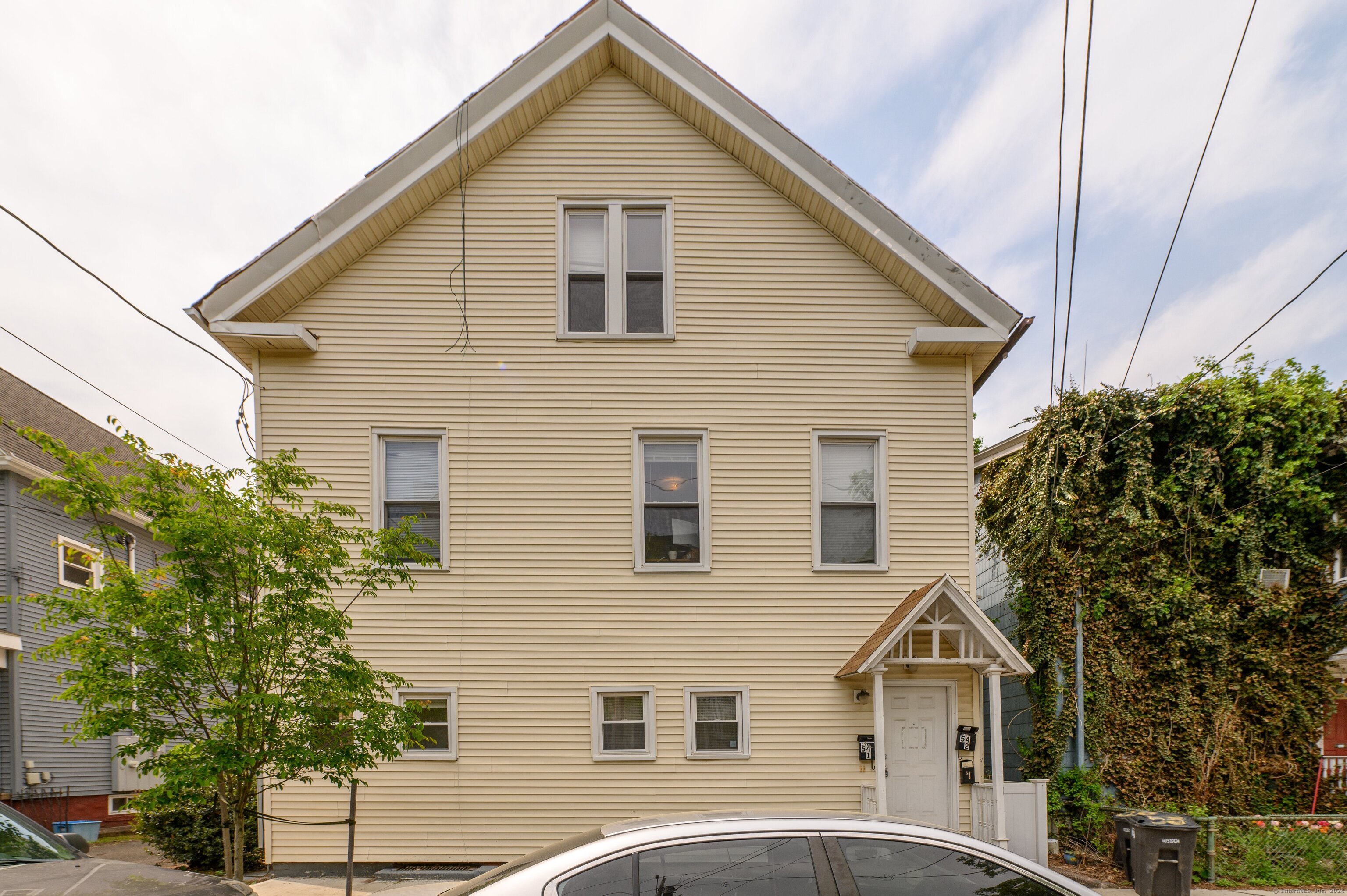 54 Mechanic Street New Haven, CT 06511 - Photo 1 of 22 a view of a white house next to a yard