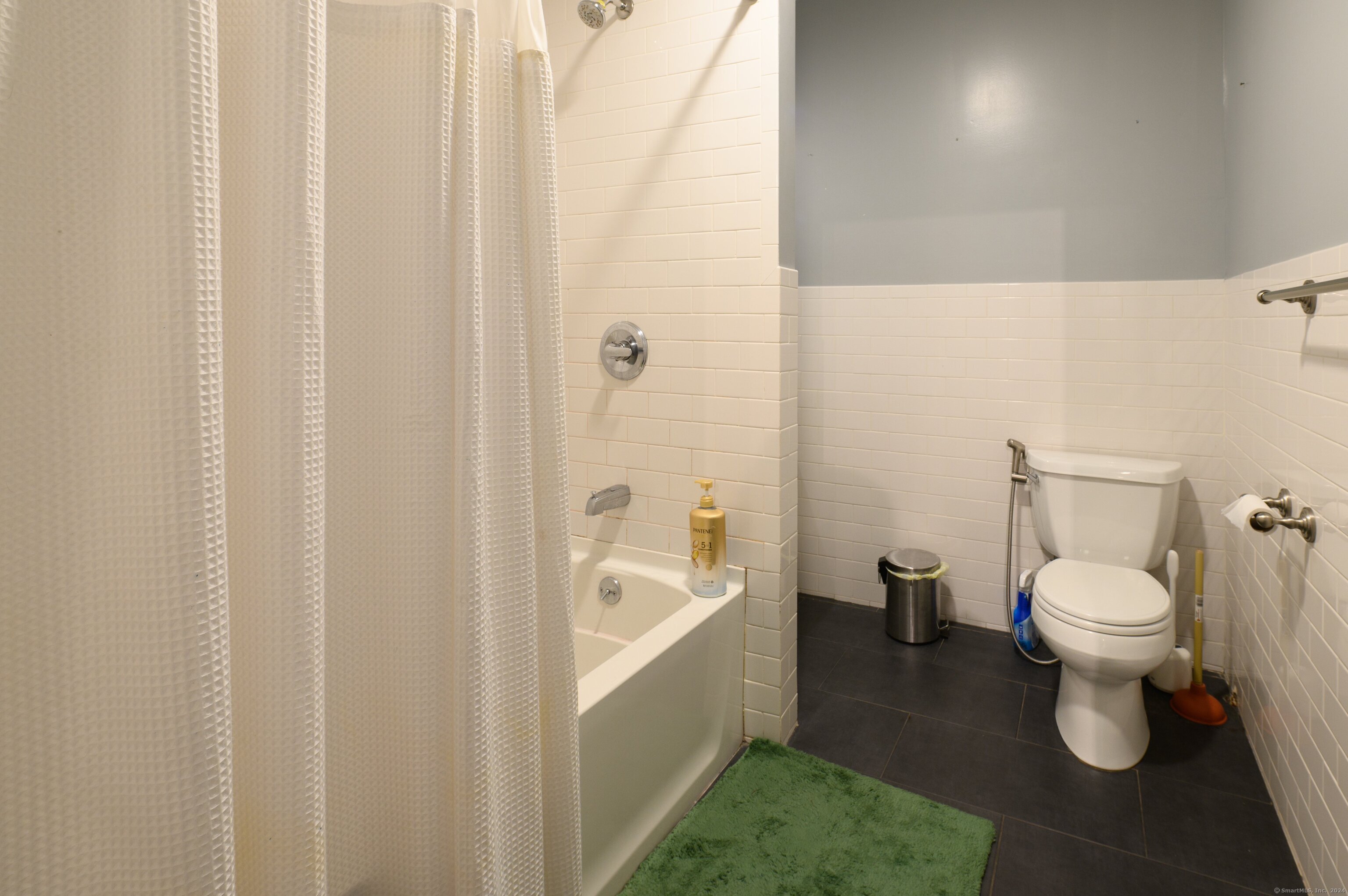 54 Mechanic Street New Haven, CT 06511 - Photo 17 of 22 a white toilet sitting next to a bathroom sink and tub