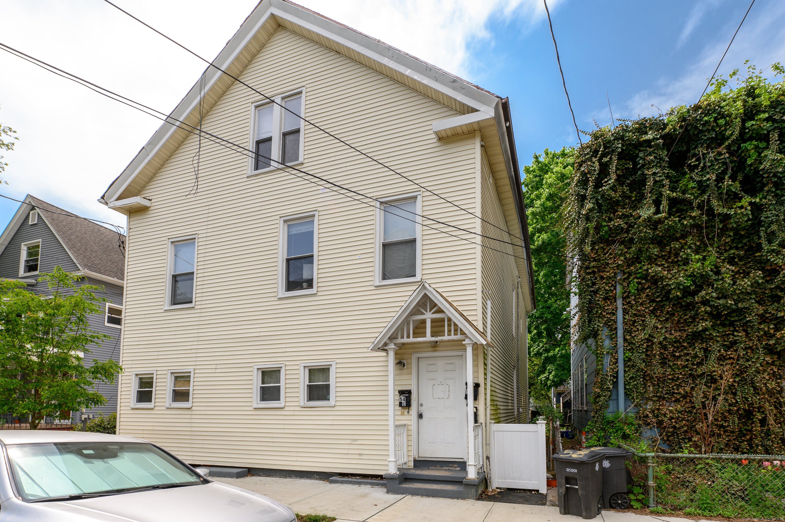 54 Mechanic Street New Haven, CT 06511 - Photo 3 of 22 a front view of a house with garage