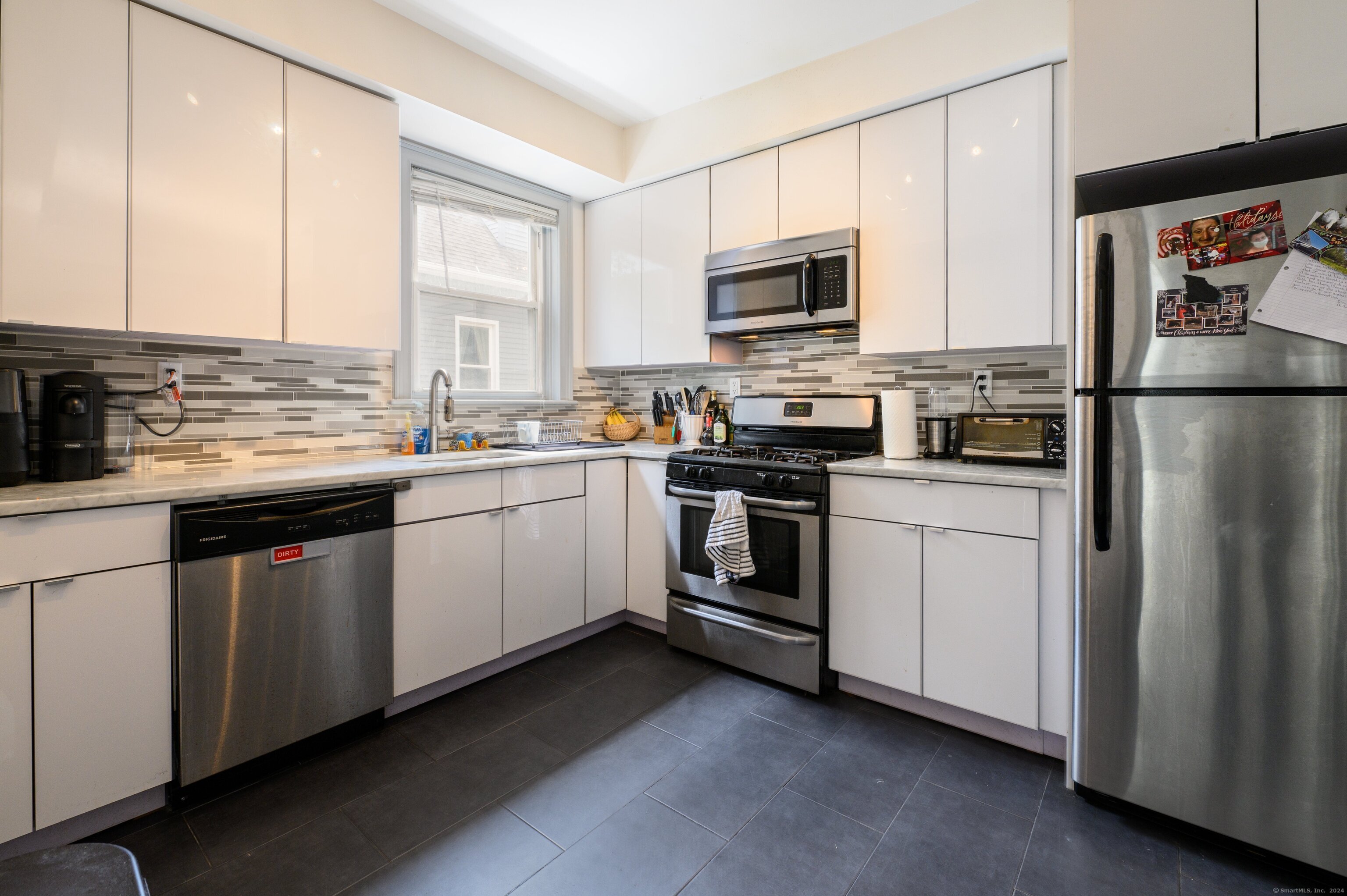 54 Mechanic Street New Haven, CT 06511 - Photo 8 of 22 a kitchen with white cabinets sink and appliances
