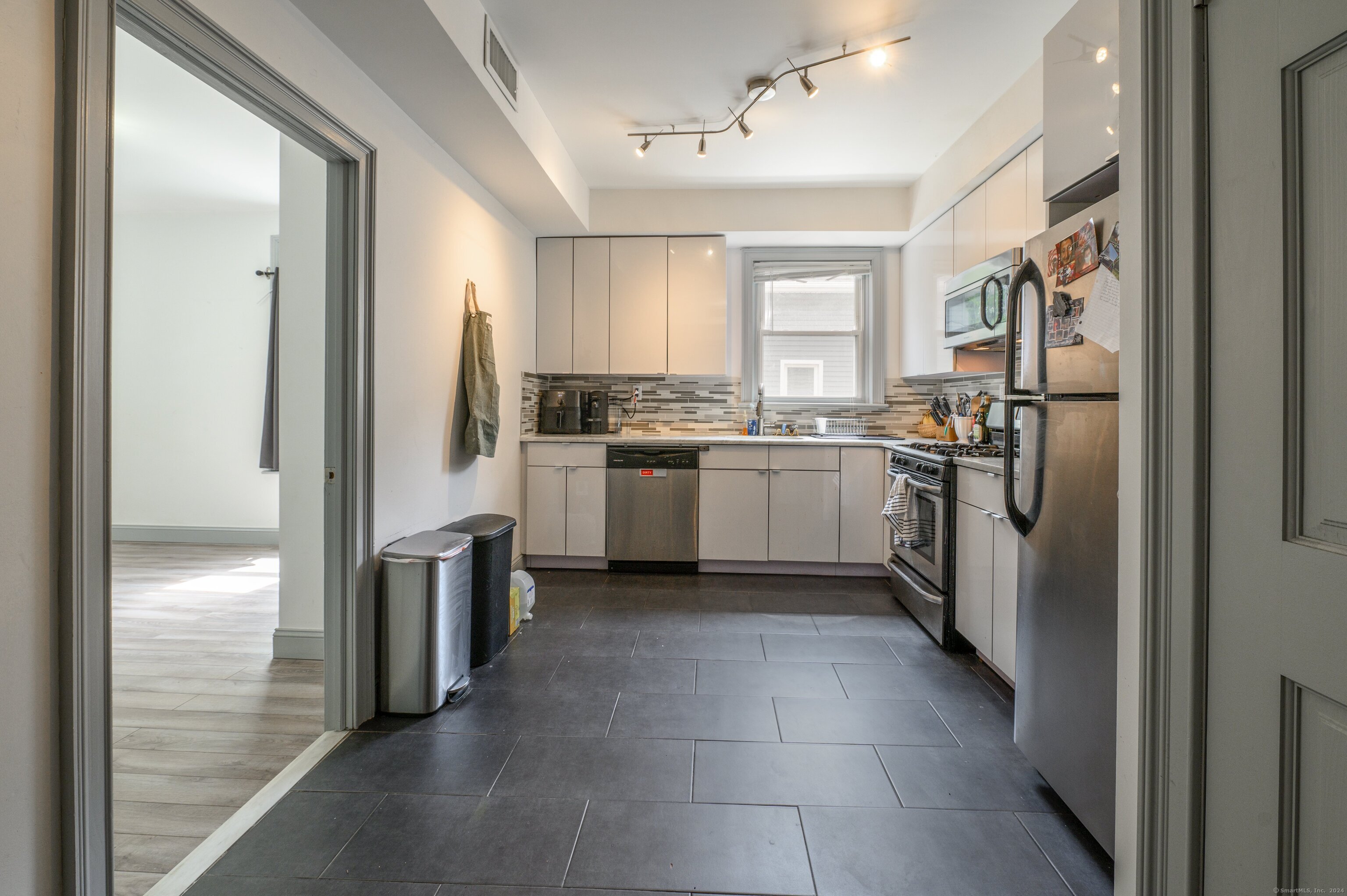 54 Mechanic Street New Haven, CT 06511 - Photo 9 of 22 a kitchen with stainless steel appliances granite countertop a refrigerator and a sink