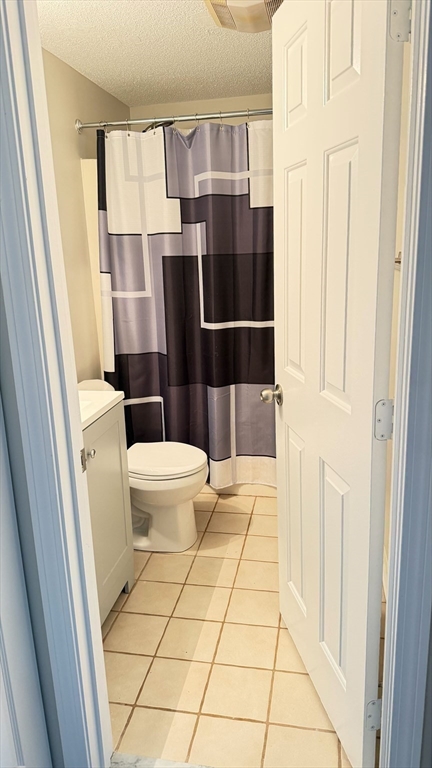8 9th Street, Unit 511 Medford, MA 02155 - Photo 11 of 12 a bathroom with a toilet and a shower