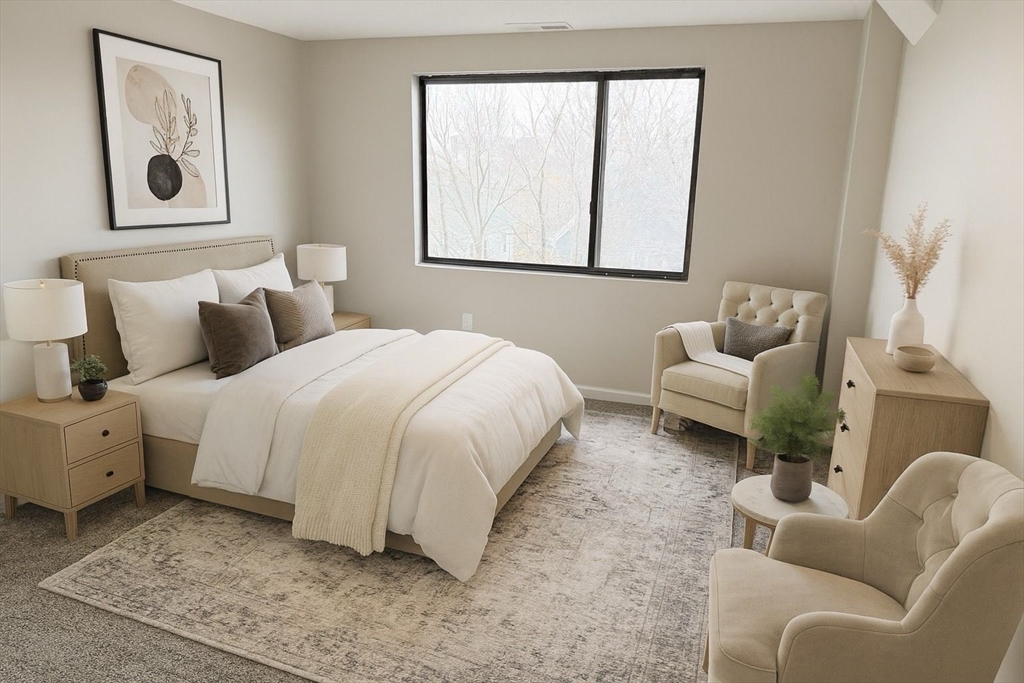 8 9th Street, Unit 511 Medford, MA 02155 - Photo 3 of 12 a spacious bedroom with a bed and a couch