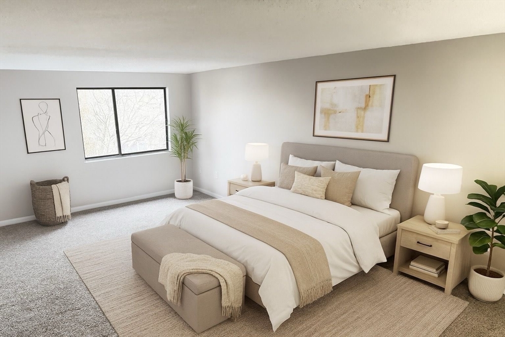 8 9th Street, Unit 511 Medford, MA 02155 - Photo 4 of 12 a bedroom with a bed and a couch