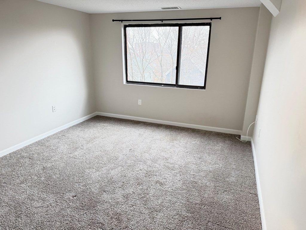 8 9th Street, Unit 511 Medford, MA 02155 - Photo 8 of 12 an empty room with a window