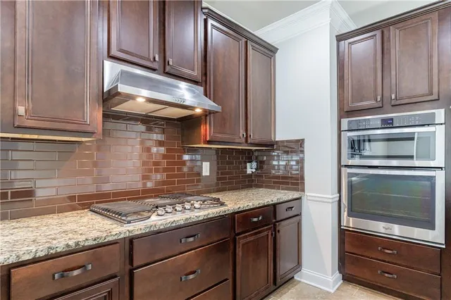 a bathroom with a granite countertop double vanity sink and a mirror