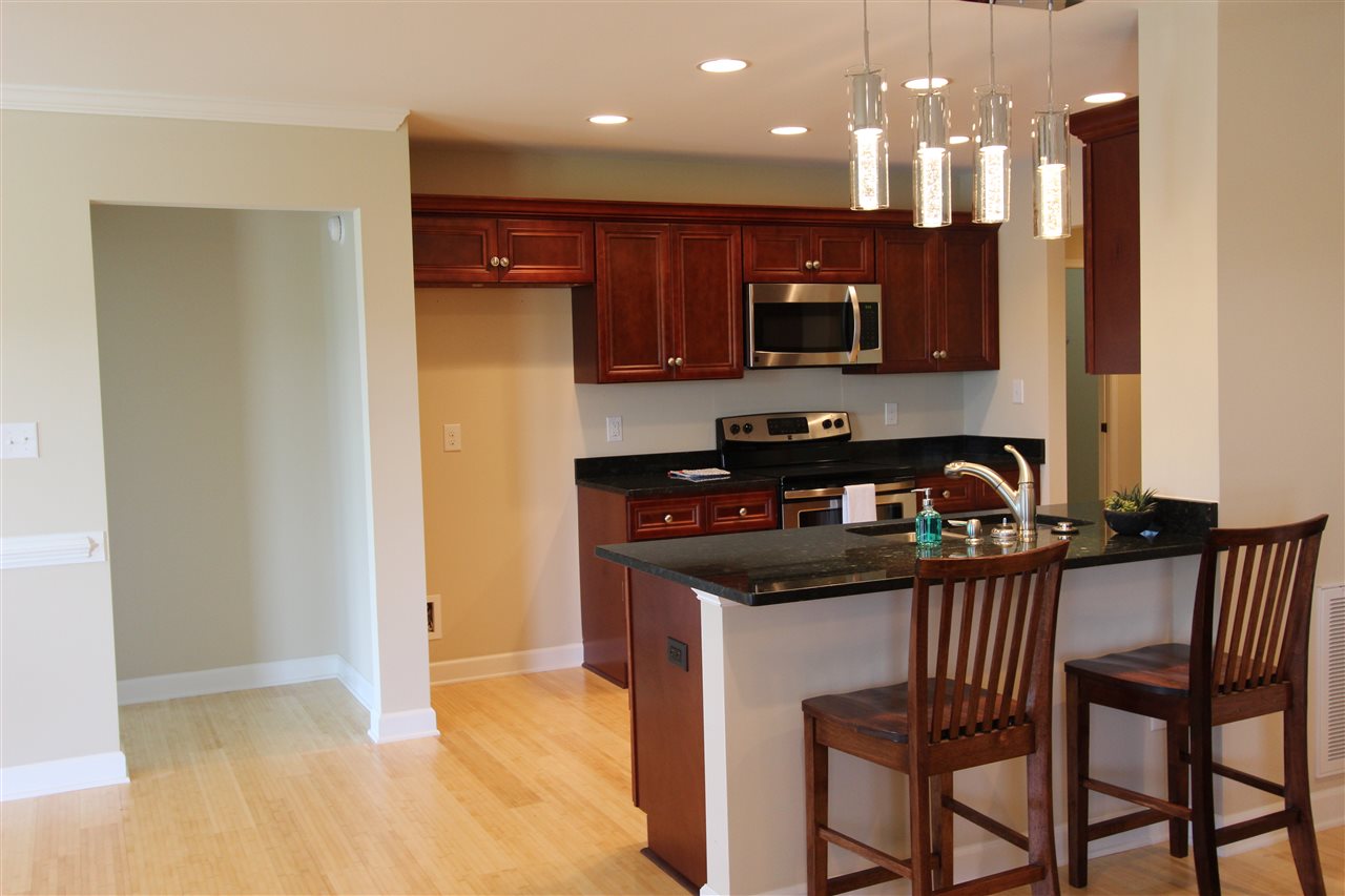 135 Waterfront Drive Raphine, VA 24472 - Photo 8 of 28 a kitchen with stainless steel appliances granite countertop a stove top oven a sink and a refrigerator
