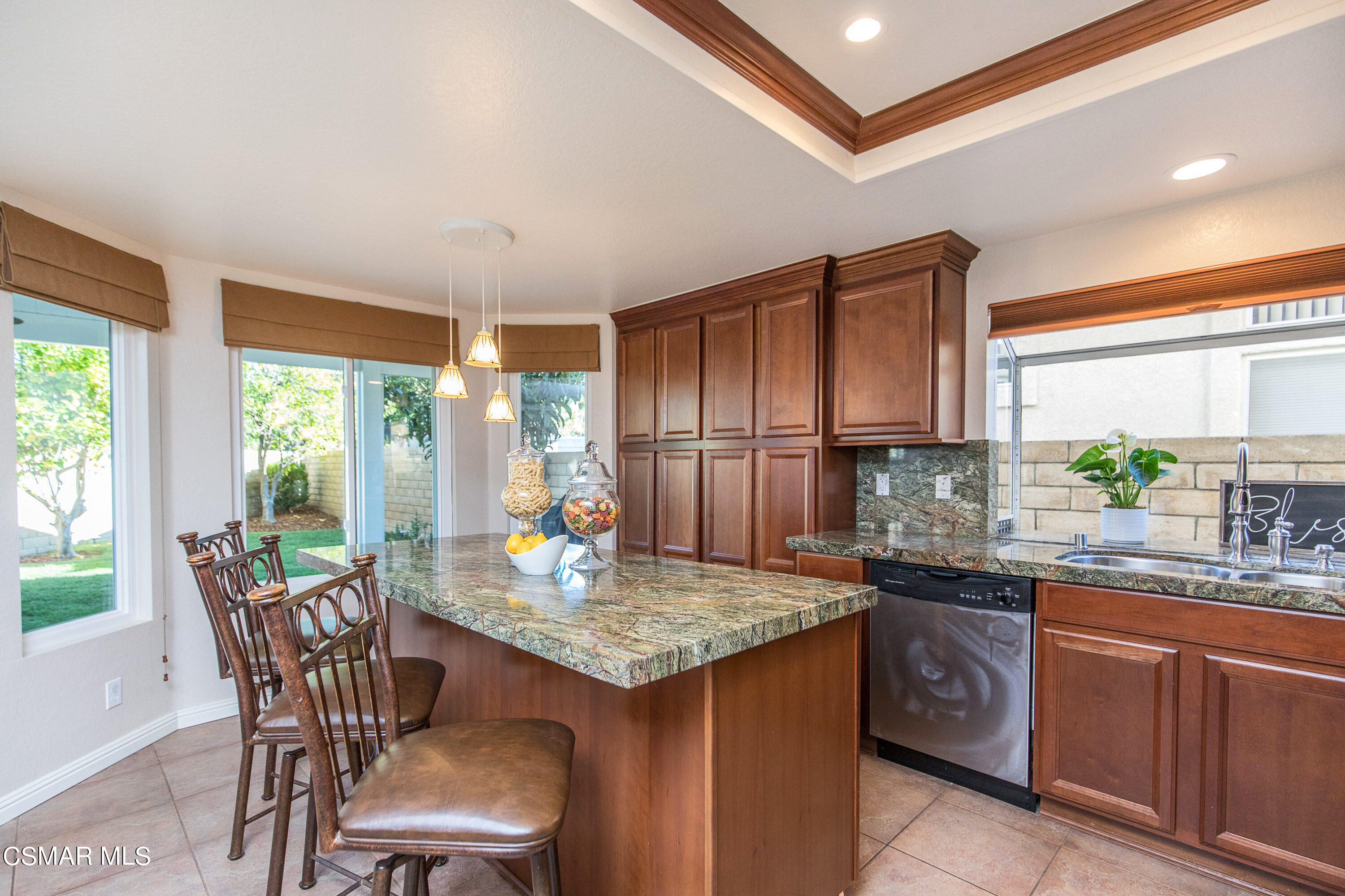516 Fairfield Road Simi Valley, CA 93065 - Photo 14 of 40 a kitchen with granite countertop wooden cabinets and dining table