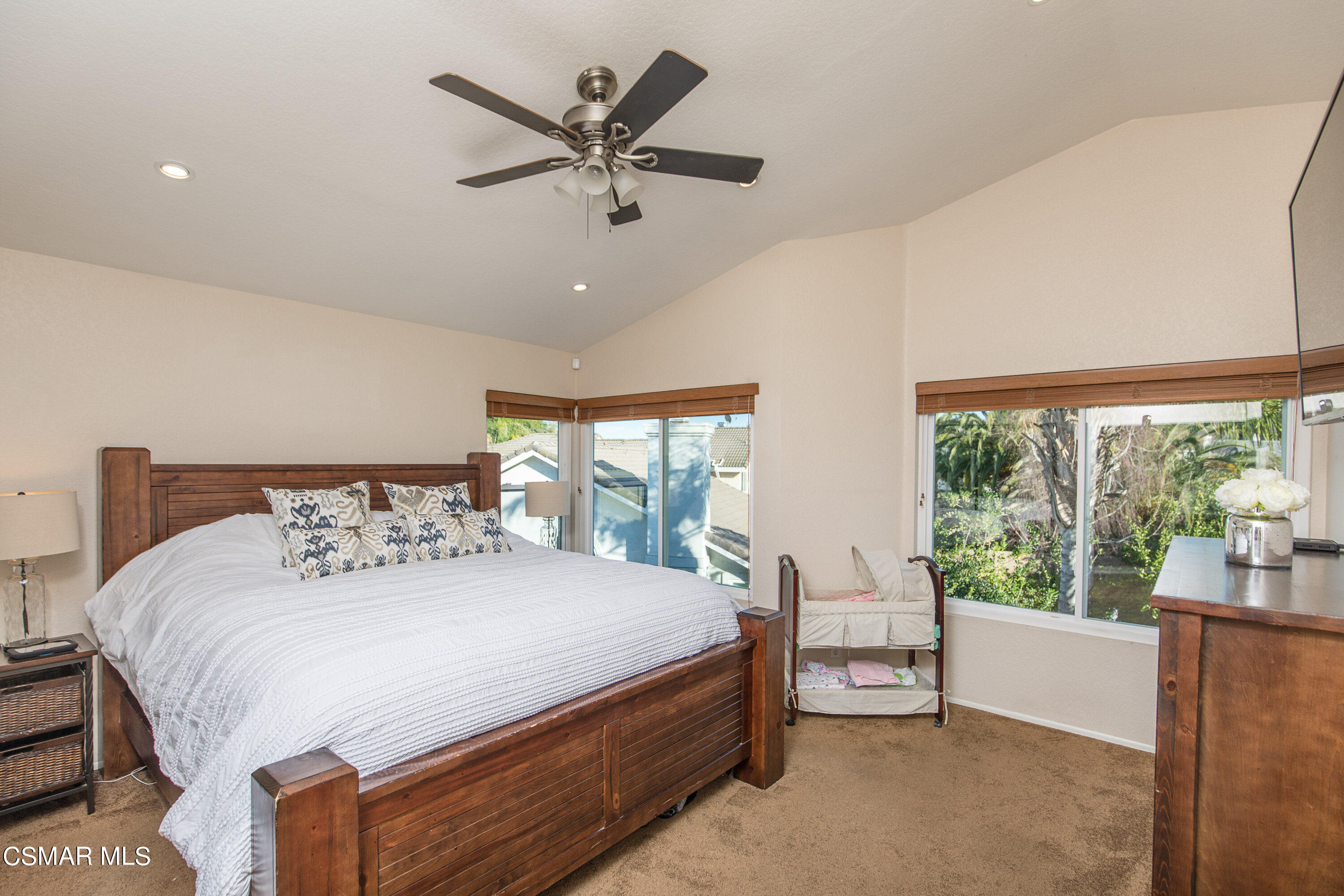 516 Fairfield Road Simi Valley, CA 93065 - Photo 22 of 40 a bedroom with a bed a chandelier and a large window