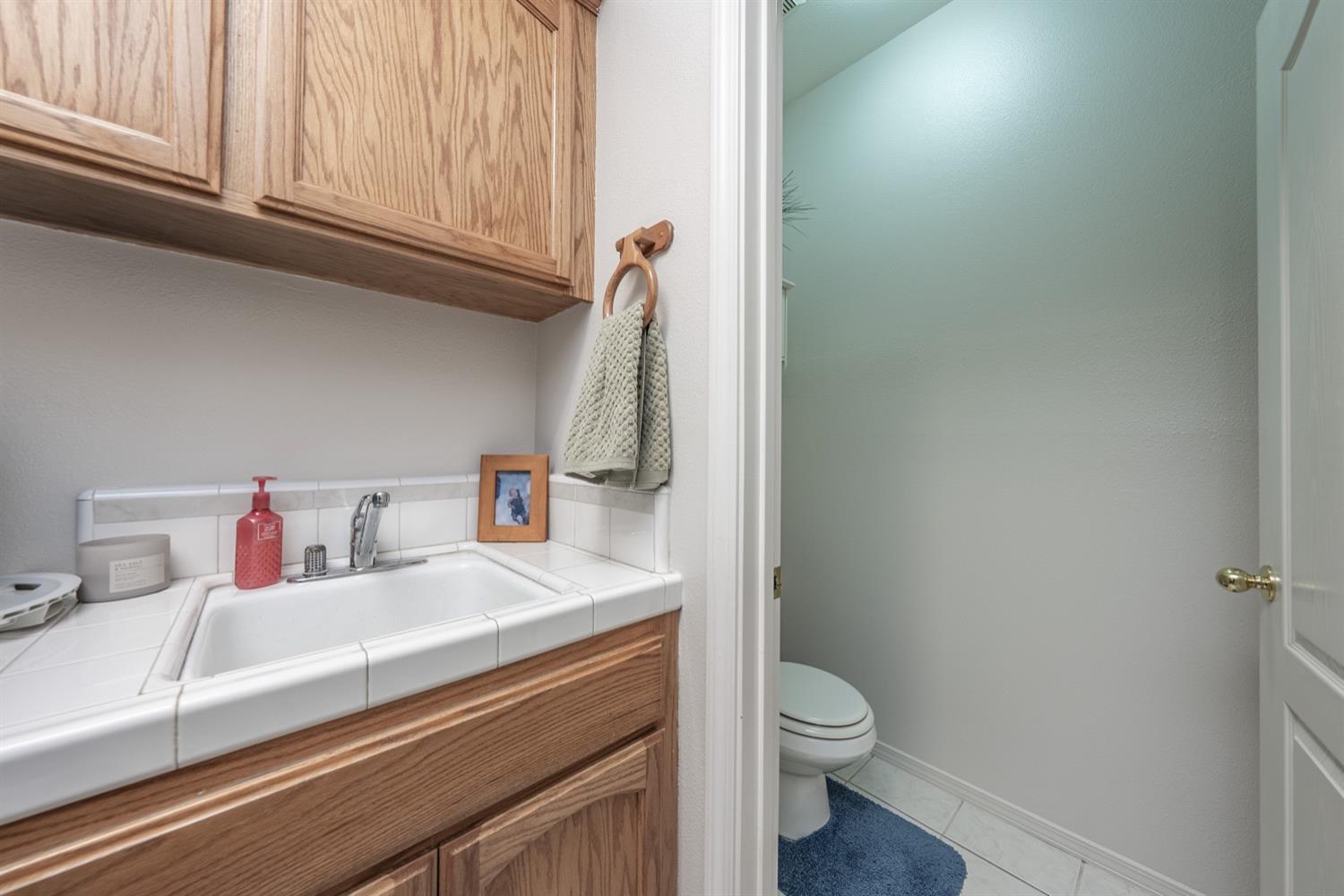 3432 Doubletree Way Madera, CA 93637 - Photo 15 of 45 a bathroom with a sink a toilet and vanity
