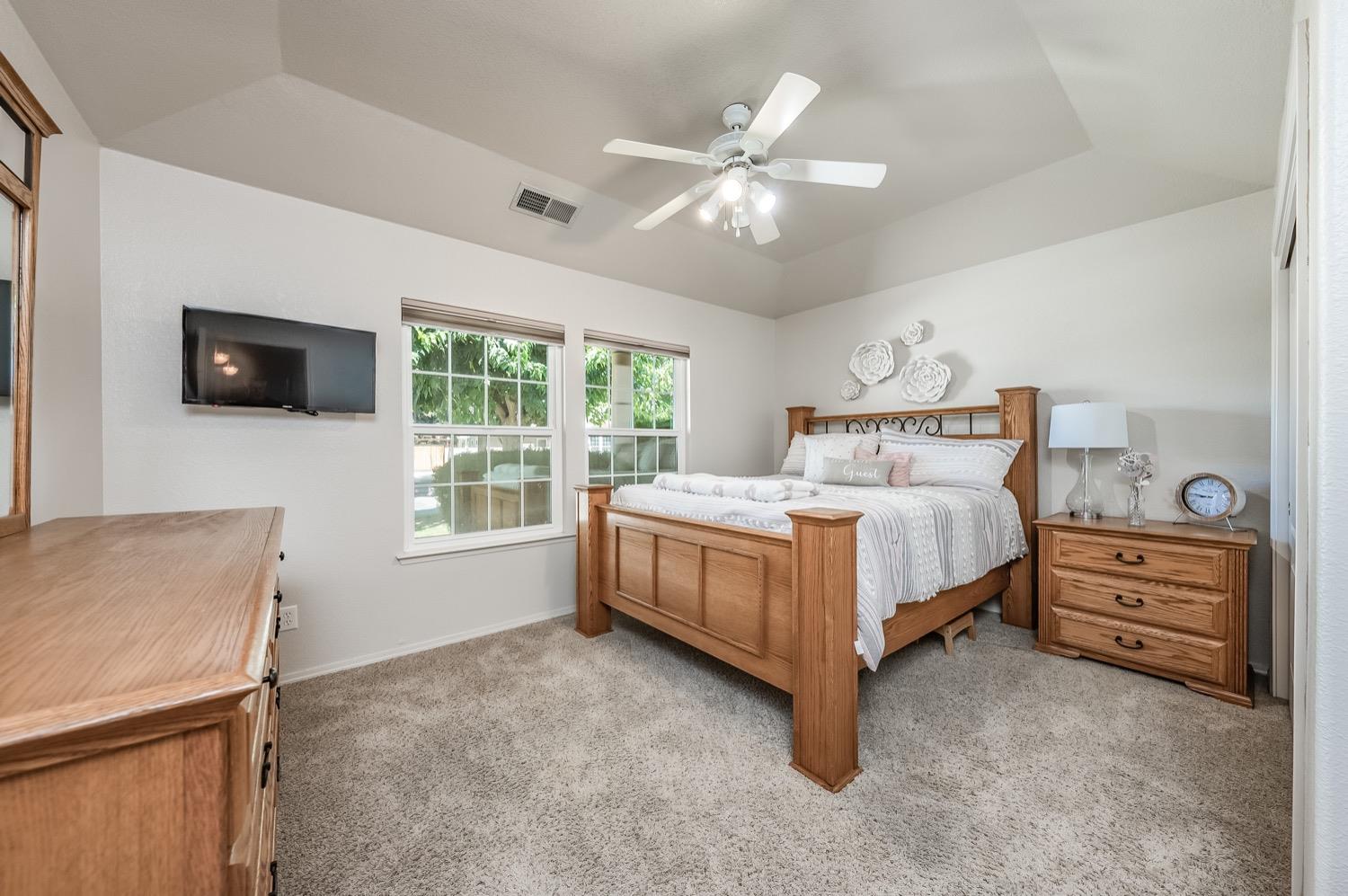 3432 Doubletree Way Madera, CA 93637 - Photo 23 of 45 a bedroom with a bed and a flat screen tv