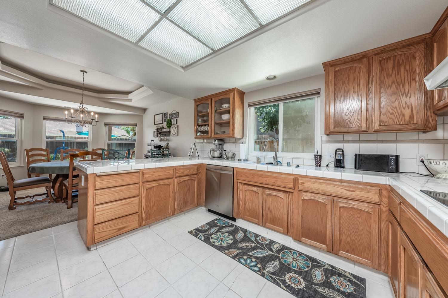 3432 Doubletree Way Madera, CA 93637 - Photo 10 of 45 a kitchen with granite countertop a sink stainless steel appliances and cabinets