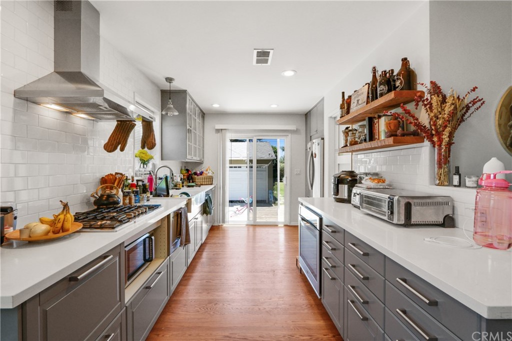 a kitchen with lots of counter top space and stainless steel appliances