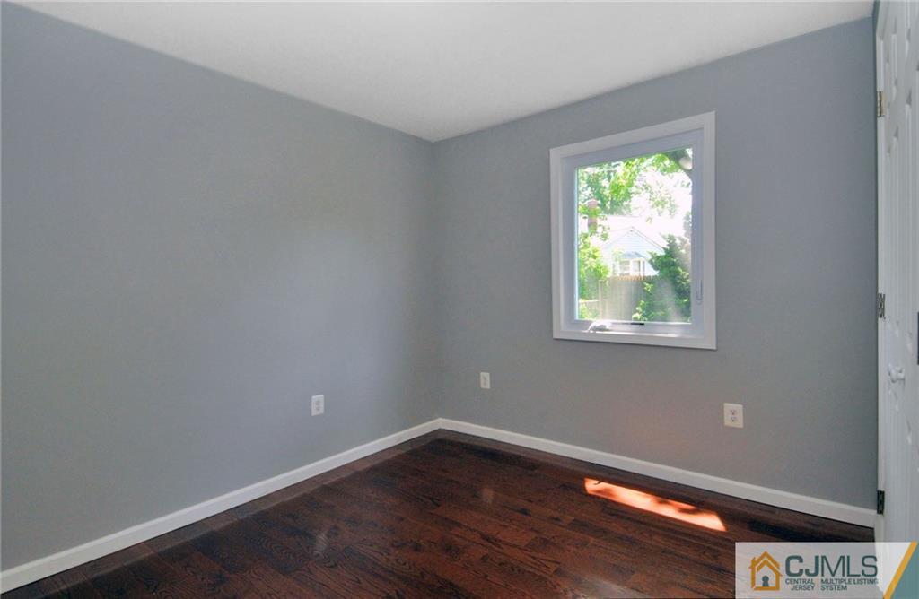 29 Stockton Road New Brunswick, NJ 08901 - Photo 11 of 21 a view of an empty room with wooden floor and a window