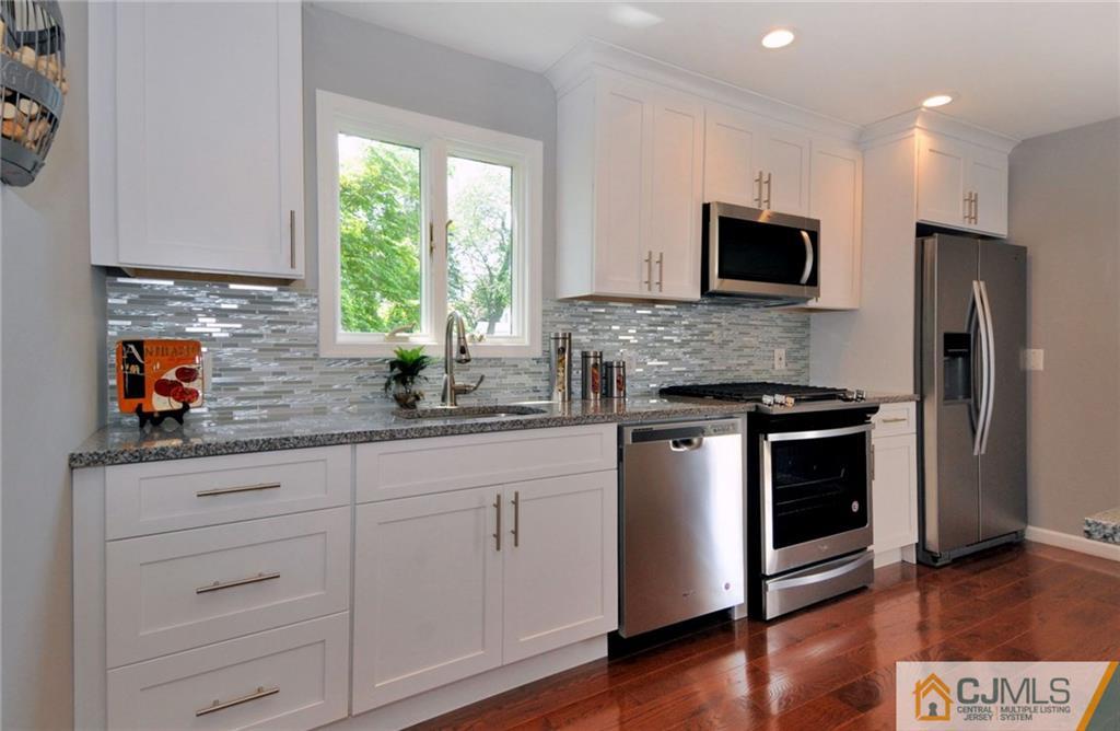 29 Stockton Road New Brunswick, NJ 08901 - Photo 7 of 21 a kitchen with stainless steel appliances granite countertop a sink stove and refrigerator