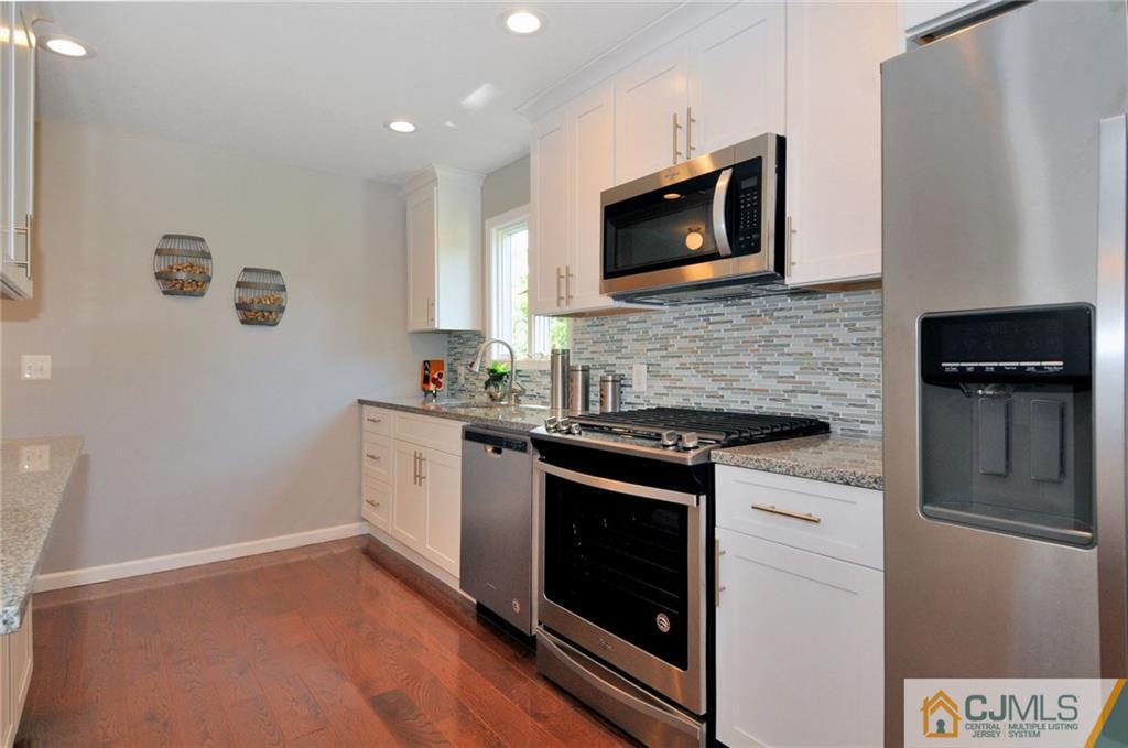 29 Stockton Road New Brunswick, NJ 08901 - Photo 9 of 21 a kitchen with granite countertop cabinets stainless steel appliances and wooden floor