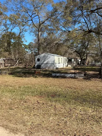 a view of house with a yard