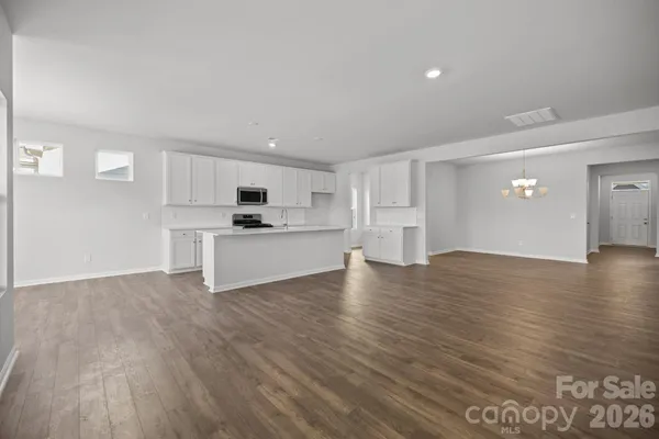 a view of a kitchen with a sink and dishwasher wooden floor
