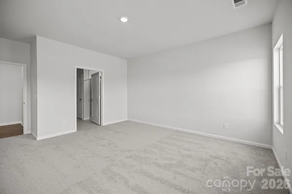 a view of an empty room and a window