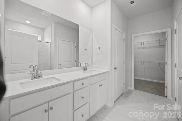 a bathroom with double sink and a mirror