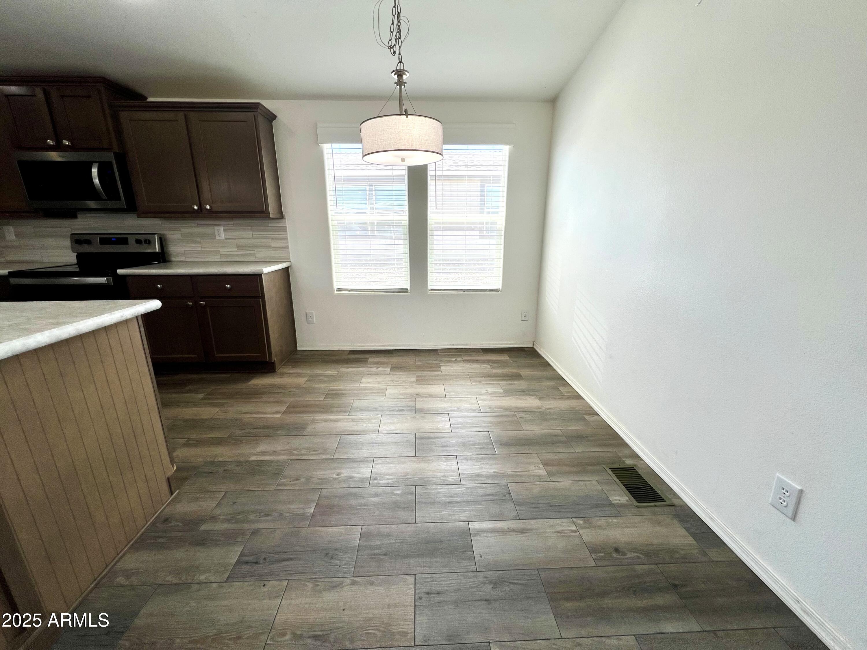 80 South Copper Canyon Loop Camp Verde, AZ 86322 - Photo 12 of 52 a kitchen with stainless steel appliances granite countertop a stove a sink and a microwave