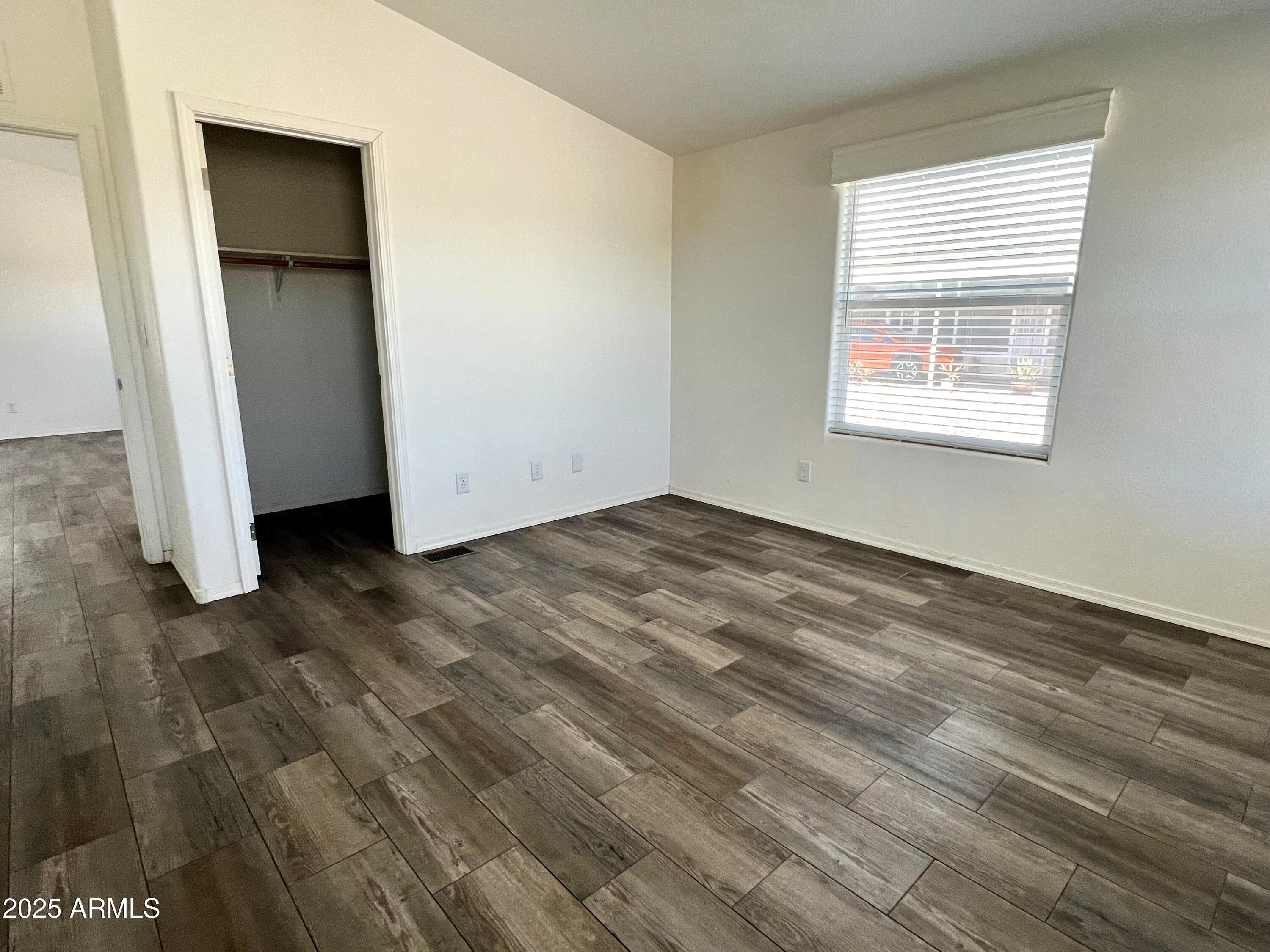 80 South Copper Canyon Loop Camp Verde, AZ 86322 - Photo 20 of 52 a view of an empty room with wooden floor and a window