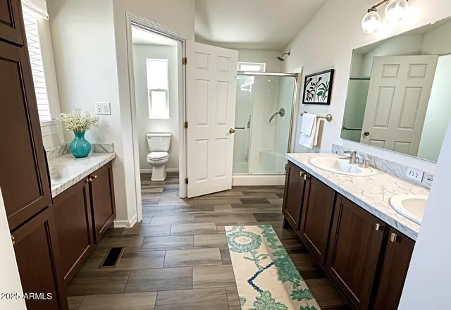 a bathroom with a double vanity sink and a mirror