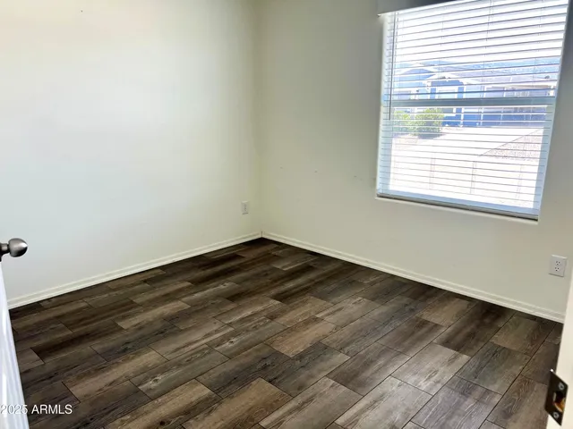 a view of a room with wooden floor and staircase
