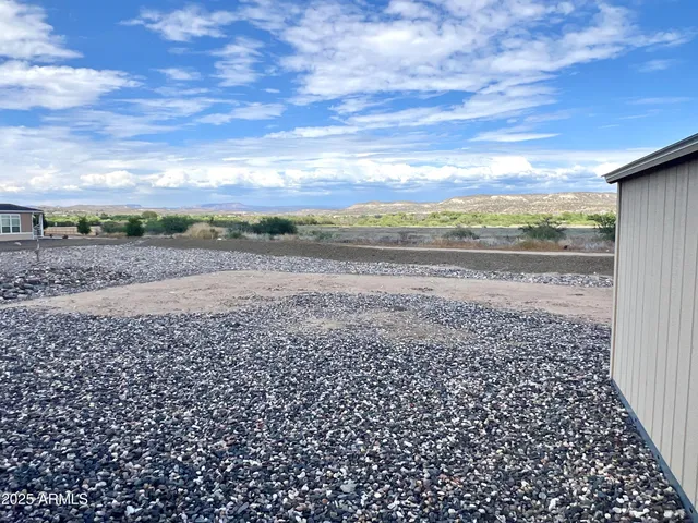 a view of a house with backyard porch and sitting area