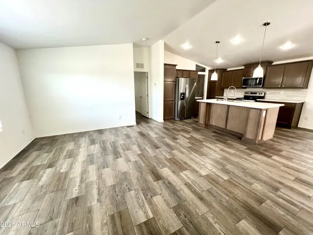 a kitchen with stainless steel appliances a refrigerator sink and microwave