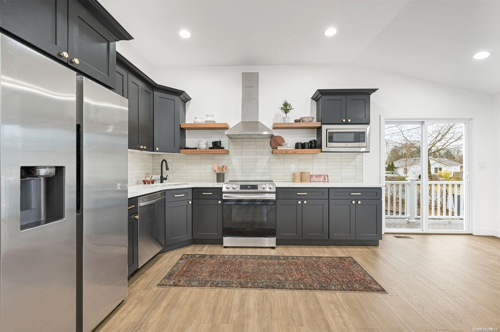13 Mills Path Lake Ronkonkoma, NY 11779 - Photo 1 of 1 a kitchen with stainless steel appliances granite countertop a stove a sink and a refrigerator