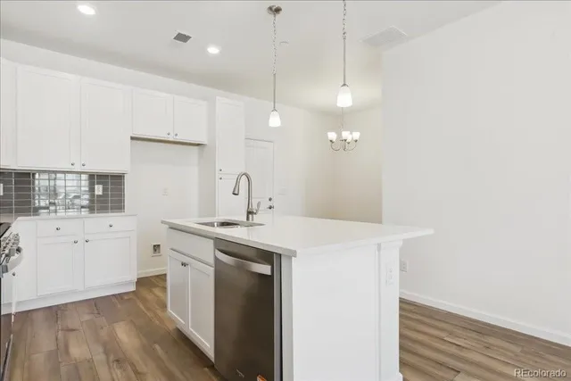 a kitchen with a sink a stove and cabinets