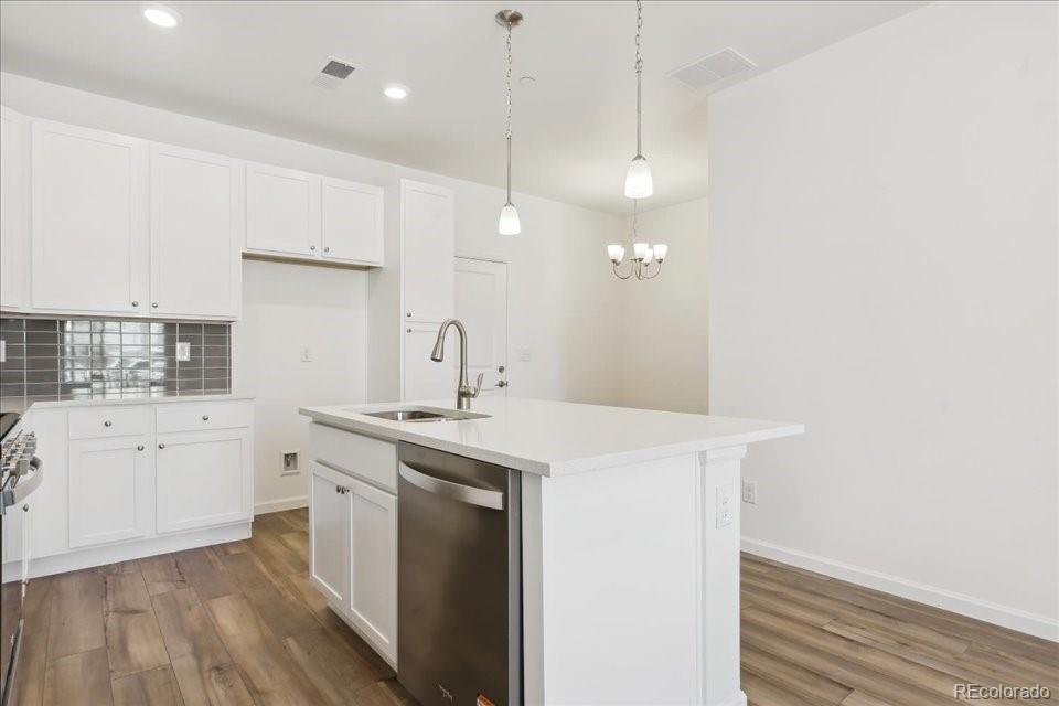 6800 Merseyside Lane, Unit 166 Castle Pines, CO 80108 - Photo 2 of 21 a kitchen with a sink a stove and cabinets