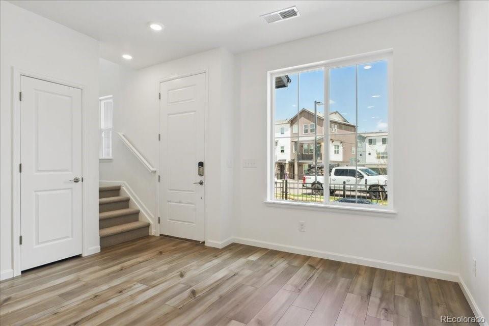 6800 Merseyside Lane, Unit 166 Castle Pines, CO 80108 - Photo 4 of 21 a view of a room with wooden floor staircase and windows